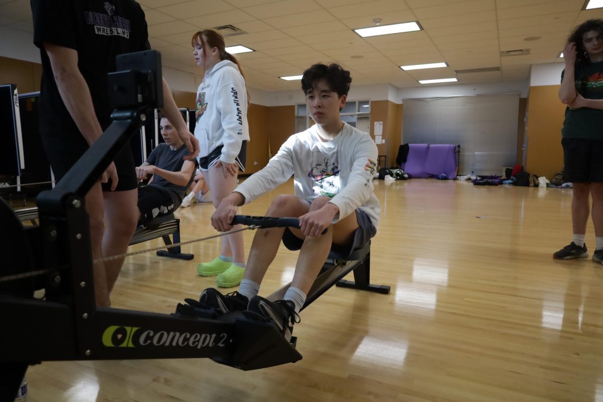 Senior Seongmin Kim works out using a rowing machine. 