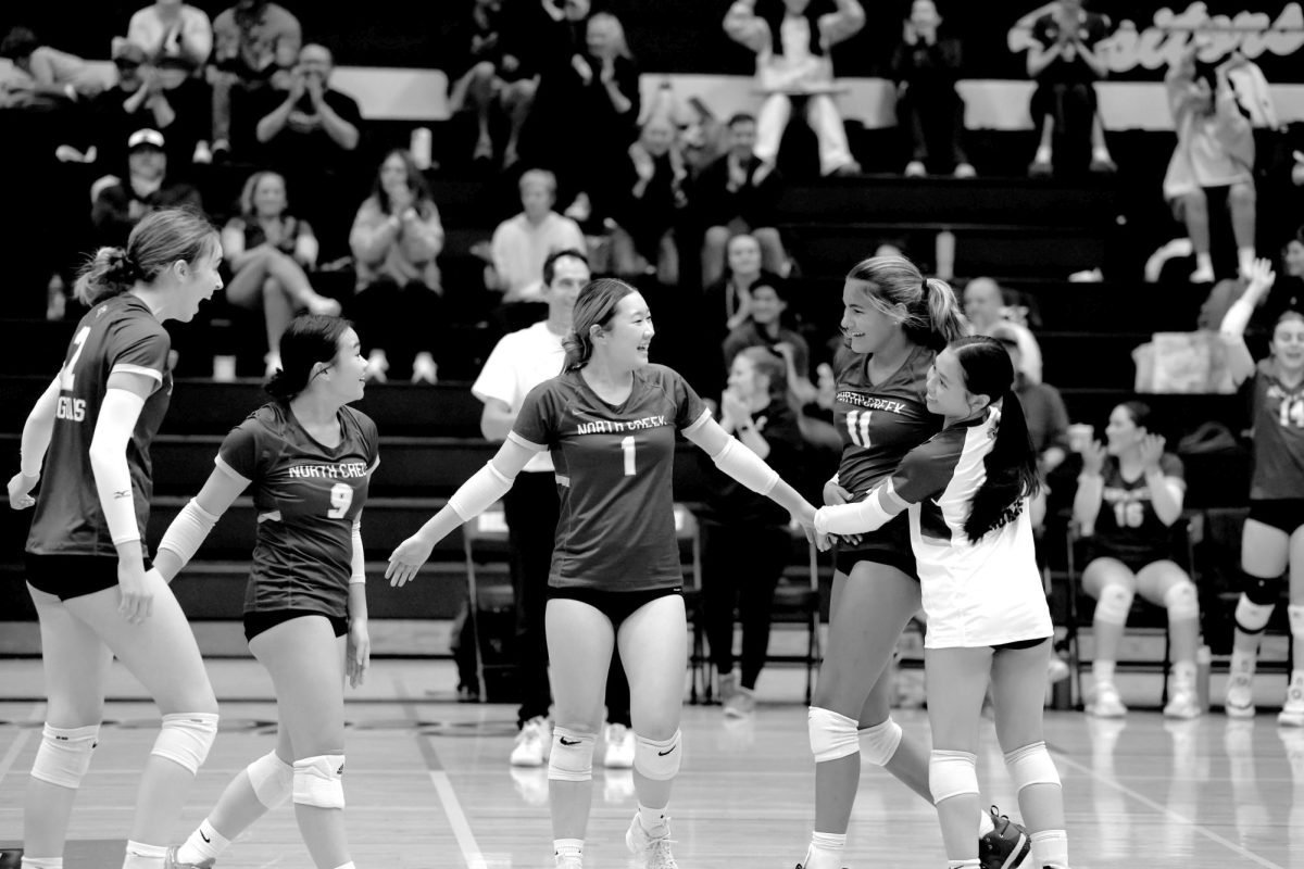 The North Creek Jaguars girls volleyball team celebrate
senior Jocelyn Grieser’s kill during their game
against the Bellevue Wolverines. The Jags fought hard,
but the game ended in a 0-3 loss.